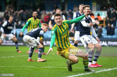Millwall 0-2 West Brom: Baggies race four points clear in boggy battle at The Den