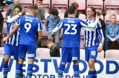 Thelo Aasgaard (r.) is congratulated by teammates after scoring Wigan's second goal against Cambridge/Photo: Wigan Athletic FC