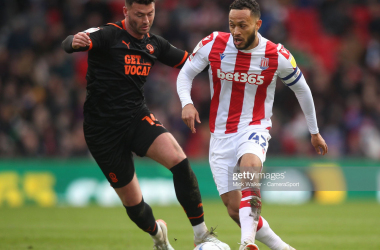 <span style="color: rgb(8, 8, 8); font-family: Lato, sans-serif; font-size: 14px; font-style: normal; text-align: start; background-color: rgb(255, 255, 255);">Blackpool's Gary Madine in action with Stoke City's Lewis Baker during the Sky Bet Championship match between Stoke City and Blackpool at Bet365 Stadium on March 5, 2022 in Stoke on Trent, England. (Photo by Mick Walker - CameraSport via Getty Images)</span>