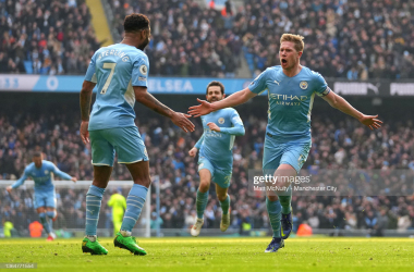 <div>MANCHESTER, ENGLAND - JANUARY 15: Kevin De Bruyne celebrates with teammate Raheem Sterling of Manchester City after scoring their team's first goal during the Premier League match between Manchester City and Chelsea at Etihad Stadium on January 15, 2022 in Manchester, England. (Photo by Matt McNulty - Manchester City/Manchester City FC via Getty Images)</div>