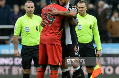 NEWCASTLE UPON TYNE, ENGLAND - JANUARY 15: Captains and ex teammates Moussa Sissoko of Watford FC (19) and Jamaal Lascelles of Newcastle United FC (6) embrace during the Premier League match between Newcastle United and Watford at St. James Park on January 15, 2022 in Newcastle upon Tyne, England. (Photo by Serena Taylor/Newcastle United via Getty Images)NEWCASTLE UPON TYNE, ENGLAND -&nbsp;