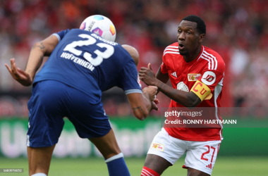 Union Berlin's Surinamese forward #27 Sheraldo Becker (R) and Hoffenheim's German defender #23 John Anthony Brooks vie for the ball during the German first division Bundesliga football match between Union Berlin and TSG 1899 Hoffenheim in Berlin, Germany, on September 23, 2023. (Photo by Ronny HARTMANN / AFP) / DFL REGULATIONS PROHIBIT ANY USE OF PHOTOGRAPHS AS IMAGE SEQUENCES AND/OR QUASI-VIDEO (Photo by RONNY HARTMANN/AFP via Getty Images)