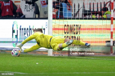 BERLIN, GERMANY - NOVEMBER 25: Finn Dahmen from FC Augsburg catches a penalty kick during the Bundesliga match between 1. FC Union Berlin and FC Augsburg at An der Alten Foersterei on November 25, 2023 in Berlin, Germany. (Photo by Inaki Esnaola/Getty Images)