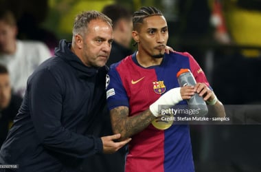 Hansi Flick and Raphinha. (Photo by Stefan Matzke - sampics/Getty Images)