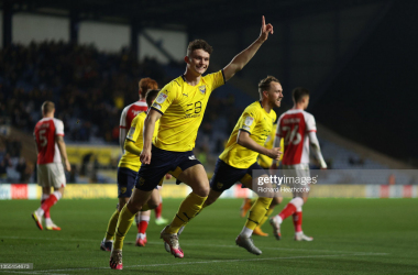 Luke McNally of Oxford celebrates scoring the first goal during the Sky Bet League One match between Oxford United and Fleetwood Town at Kassam Stadium on November 23, 2021 in Oxford, England.