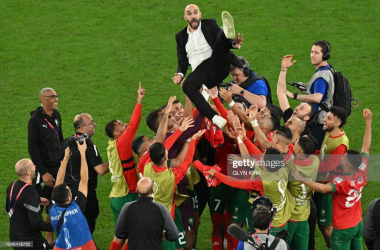 <div>Moroccan Manager&nbsp;<strong>Walid Regragui being lifted into the air after their historic win against Spain. </strong><strong>(Photo by Glyn Kirk/AFP via Getty Images)</strong></div>