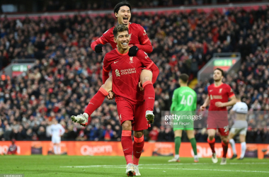 LIVERPOOL, ENGLAND - JANUARY 16: Takumi Minamino of Liverpool celebrates with Roberto Firmino after scoring their team's third goal during the Premier League match between Liverpool and Brentford at Anfield on January 16, 2022 in Liverpool, England. (Photo by Michael Regan/Getty Images)