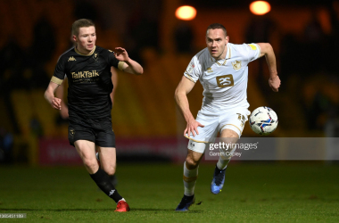 BURSLEM, ENGLAND - JANUARY 18: Chris Hussey of Port Vale gets past Stephen Kelly of Salford during the Sky Bet League Two match between Port Vale and Salford City at Vale Park on January 18, 2022 in Burslem, England. (Photo by Gareth Copley/Getty Images)